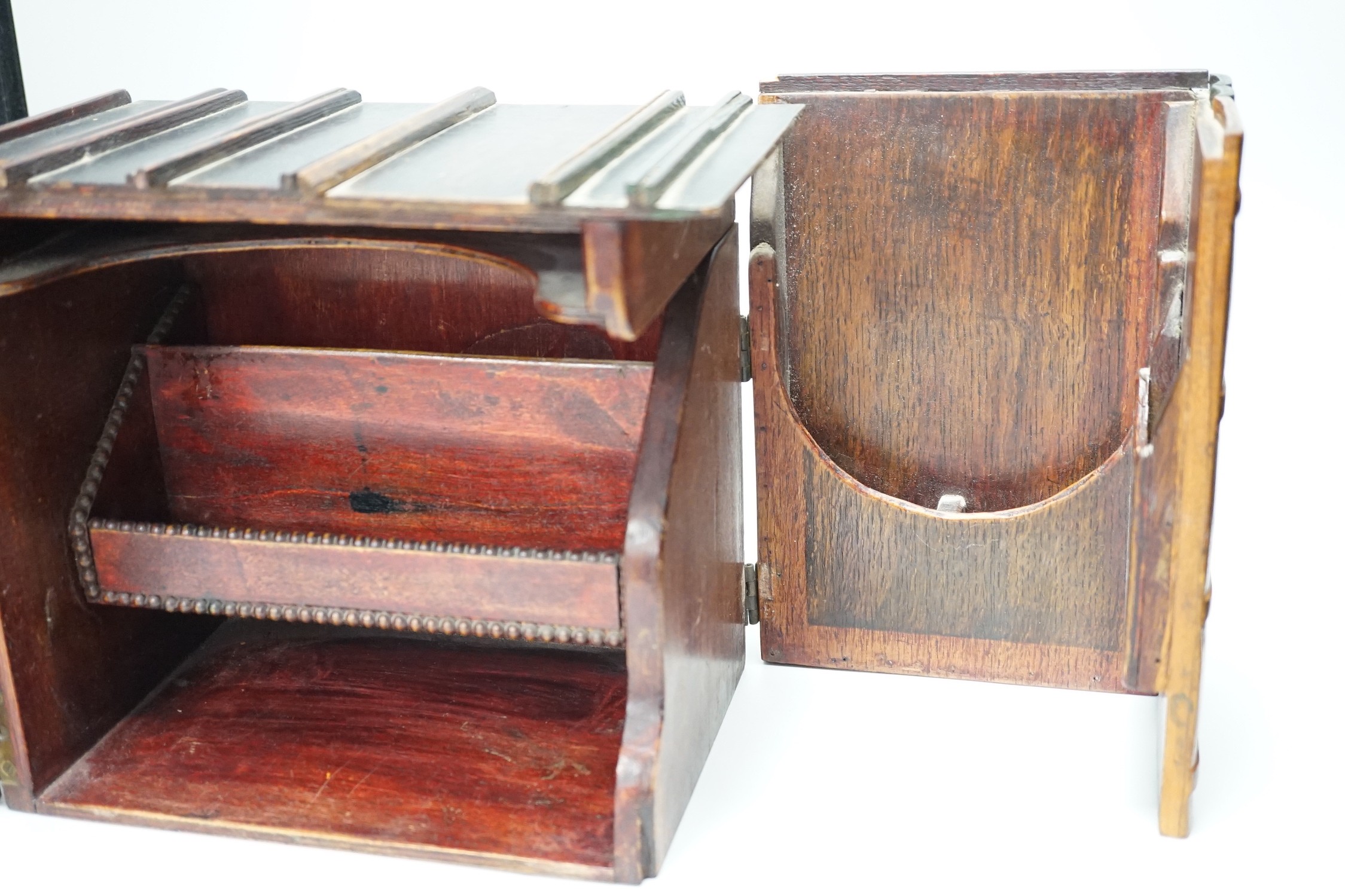 An early 20th century painted carved oak novelty stationary box modelled as books, 27cm wide, 23cm tall, 16cm deep